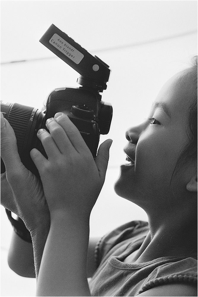 Camper photographing in black and white with a flash-mounted camera