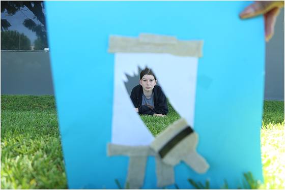 A cyanotype print drying on an easel outside