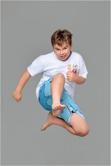 Camper caught mid-jump against a studio backdrop