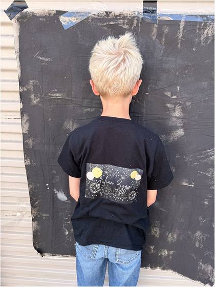 Camper standing in front of the canvas backdrop they painted