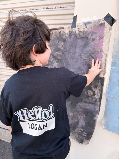 Camper standing in front of the canvas backdrop they painted
