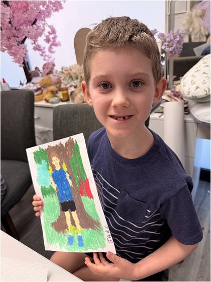 Camper holding up a finished collage