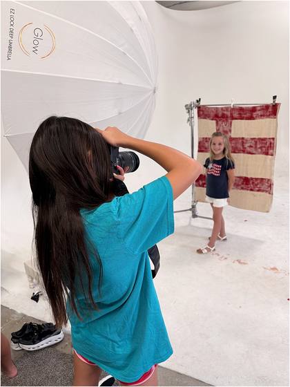 Camper standing in front of the canvas backdrop they painted