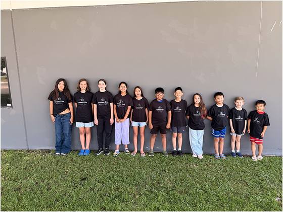 The full camp group lined up outside the studio