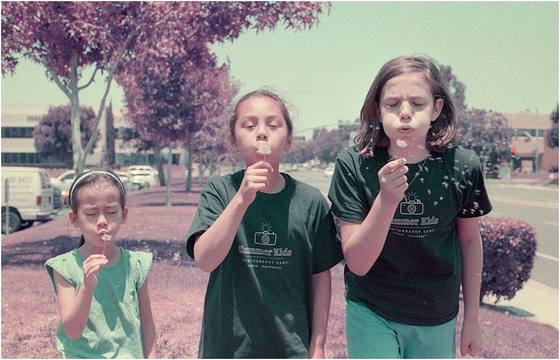Campers photographed outdoors with a color-shifted edit