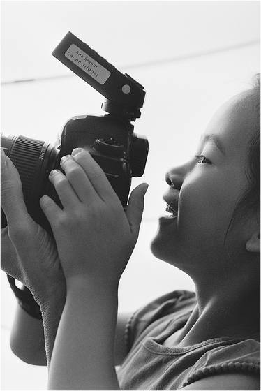 Black and white photograph of a camper with a camera
